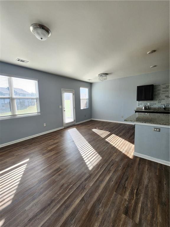 unfurnished living room with dark hardwood / wood-style flooring