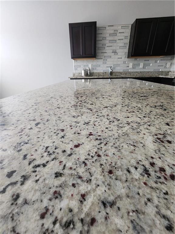 kitchen featuring light stone countertops and decorative backsplash