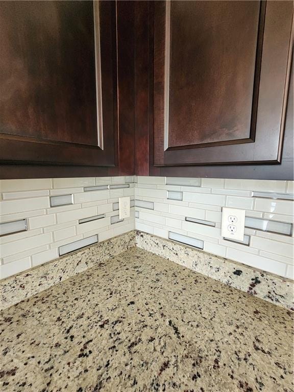 details featuring tasteful backsplash and light stone counters