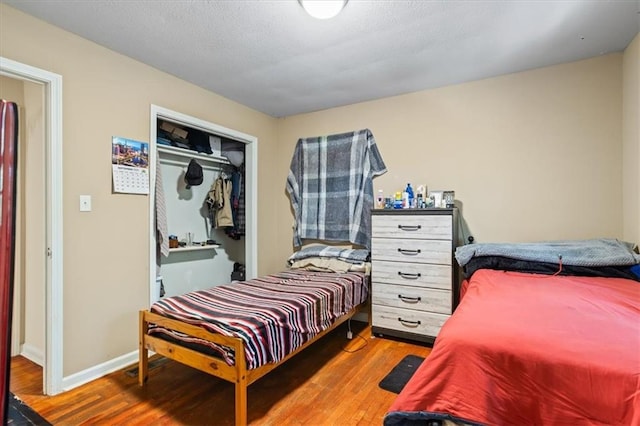 bedroom featuring a closet and wood-type flooring