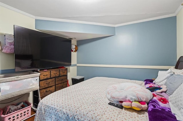 bedroom with ornamental molding and vaulted ceiling