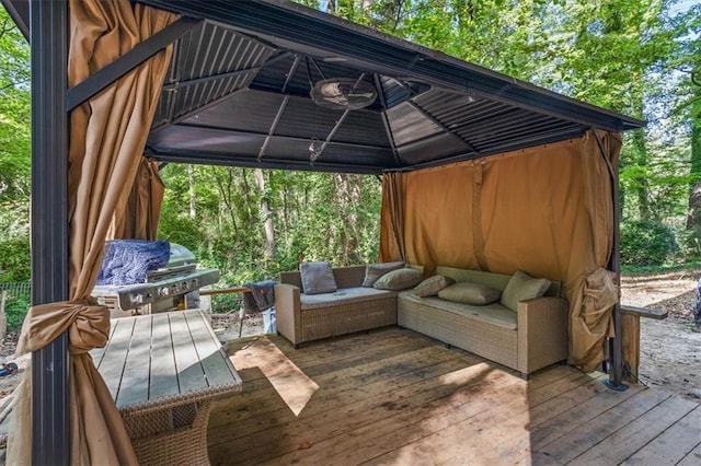 wooden deck with a gazebo, an outdoor hangout area, and area for grilling