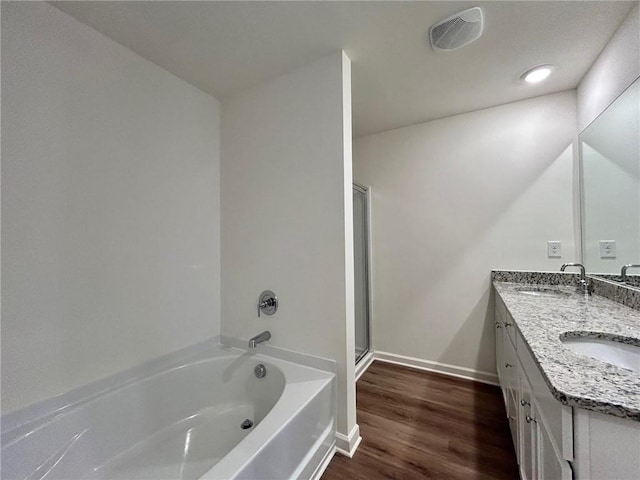 1958 Asher Ln Unit 50, Conyers, GA 30013 - full bathroom with a shower stall, a bath, double vanity, wood finished floors, and baseboards