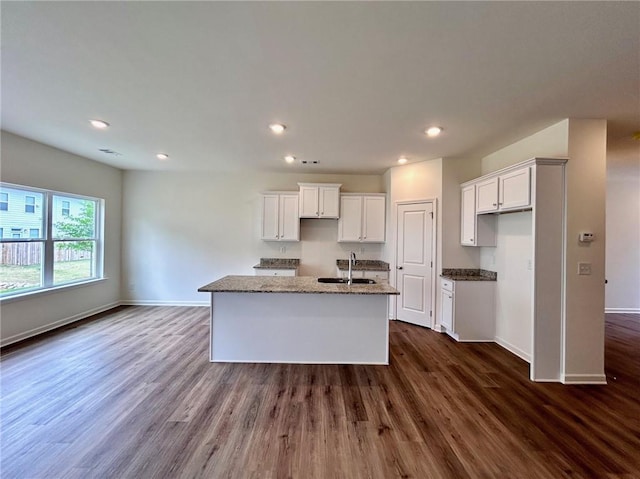 1958 Asher Ln Unit 50, Conyers, GA 30013 - kitchen with a sink, an island with sink, baseboards, recessed lighting, and dark wood-style flooring
