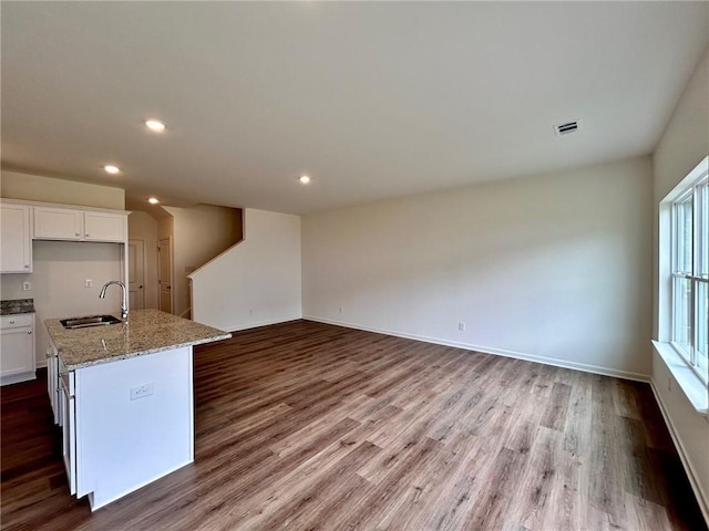 1958 Asher Ln Unit 50, Conyers, GA 30013 - kitchen with a sink, dark wood-type flooring, white cabinets, recessed lighting, and light stone countertops