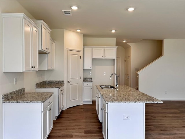 1958 Asher Ln Unit 50, Conyers, GA 30013 - kitchen with a sink, dark wood-type flooring, light stone countertops, a center island with sink, and recessed lighting