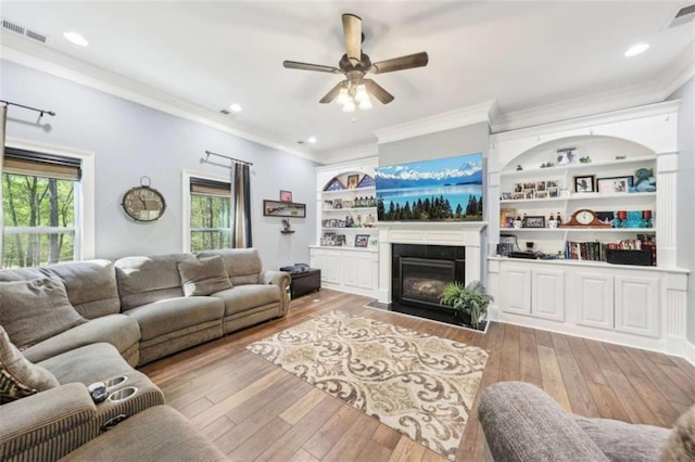 270 Morrow Rd, Newborn, GA 30056 - living area featuring crown molding, healthy amount of natural light, light wood-style flooring, ceiling fan, and a tile fireplace