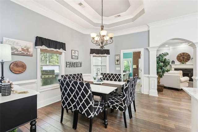 270 Morrow Rd, Newborn, GA 30056 - dining room featuring arched walkways, crown molding, a chandelier, hardwood / wood-style flooring, and a wainscoted wall