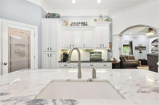 270 Morrow Rd, Newborn, GA 30056 - kitchen with a sink, ornamental molding, open floor plan, a ceiling fan, and arched walkways