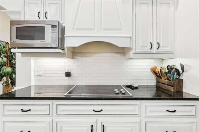270 Morrow Rd, Newborn, GA 30056 - kitchen with white microwave, black electric cooktop, and white cabinetry