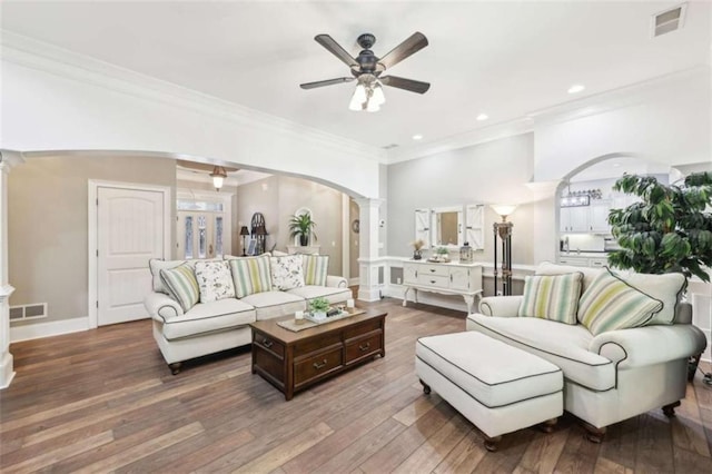 270 Morrow Rd, Newborn, GA 30056 - living room with arched walkways, ornate columns, a ceiling fan, crown molding, and wood-type flooring