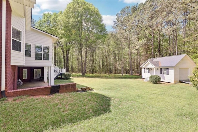 270 Morrow Rd, Newborn, GA 30056 - view of grassy yard featuring an outbuilding and a garage