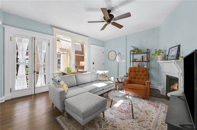 746 N Highland Ave NE Unit 7, Atlanta, GA 30306 - living area with a warm lit fireplace, wood finished floors, a ceiling fan, and baseboards