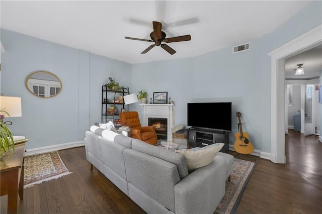 746 N Highland Ave NE Unit 7, Atlanta, GA 30306 - living room with a warm lit fireplace, ceiling fan, dark wood finished floors, and baseboards
