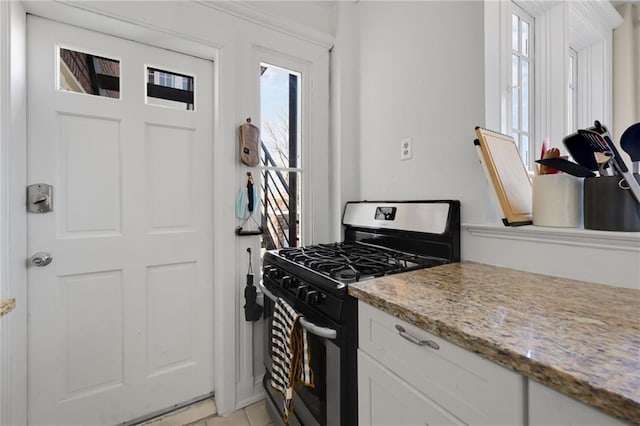 746 N Highland Ave NE Unit 7, Atlanta, GA 30306 - kitchen featuring gas stove, white cabinets, and light stone counters