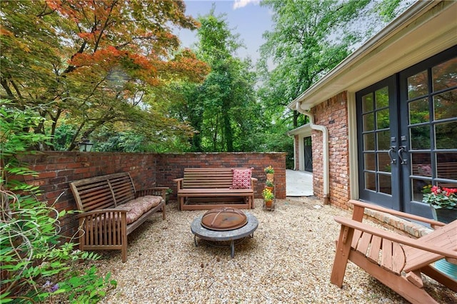 view of patio / terrace with a fire pit and french doors