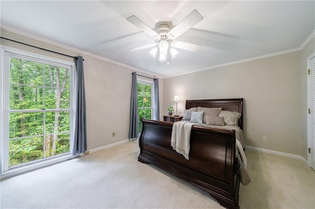 bedroom with baseboards, ornamental molding, light carpet, and a ceiling fan