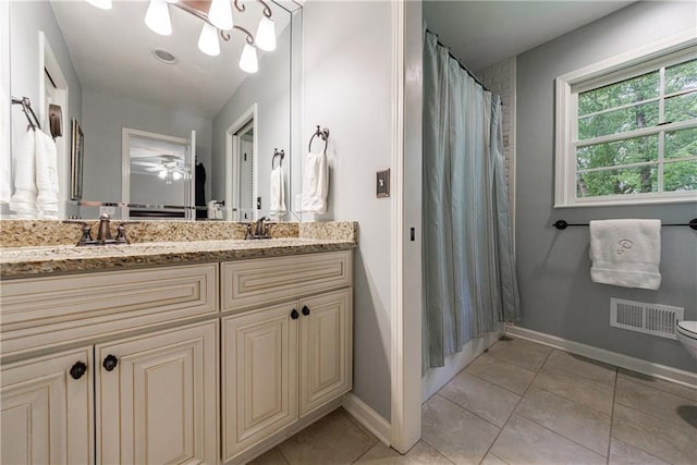 bathroom featuring baseboards, visible vents, a sink, and tile patterned floors