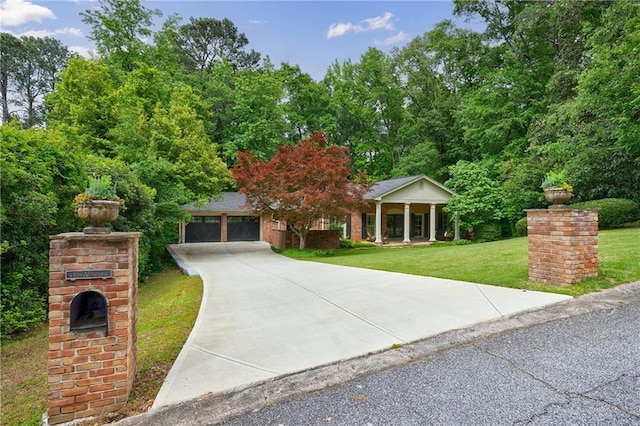greek revival inspired property with driveway, an attached garage, a porch, and a front lawn
