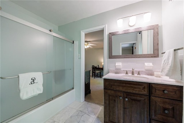 bathroom with vanity, marble finish floor, a ceiling fan, backsplash, and bath / shower combo with glass door