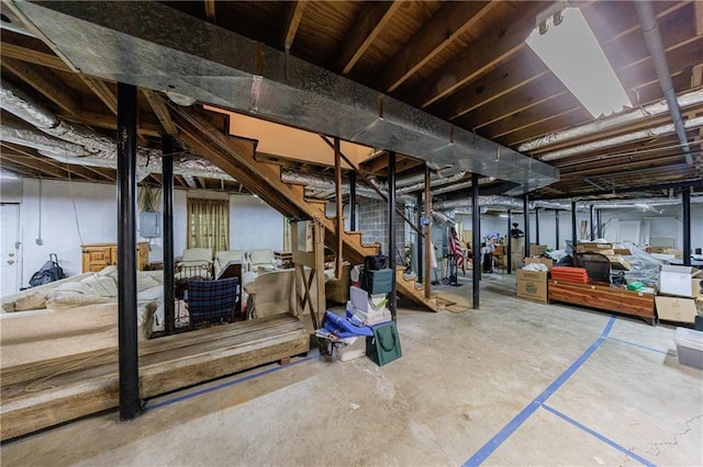 unfinished basement featuring stairs