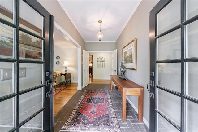 entrance foyer with crown molding, baseboards, and brick floor