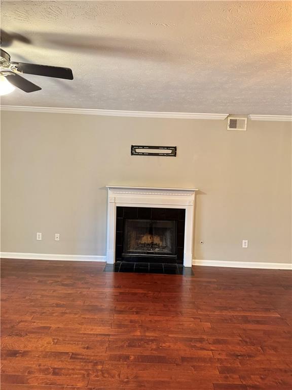 121 Brittany Ct, Duluth, GA 30096 - detailed view of ceiling fan, wood finished floors, a tile fireplace, a textured ceiling, and crown molding
