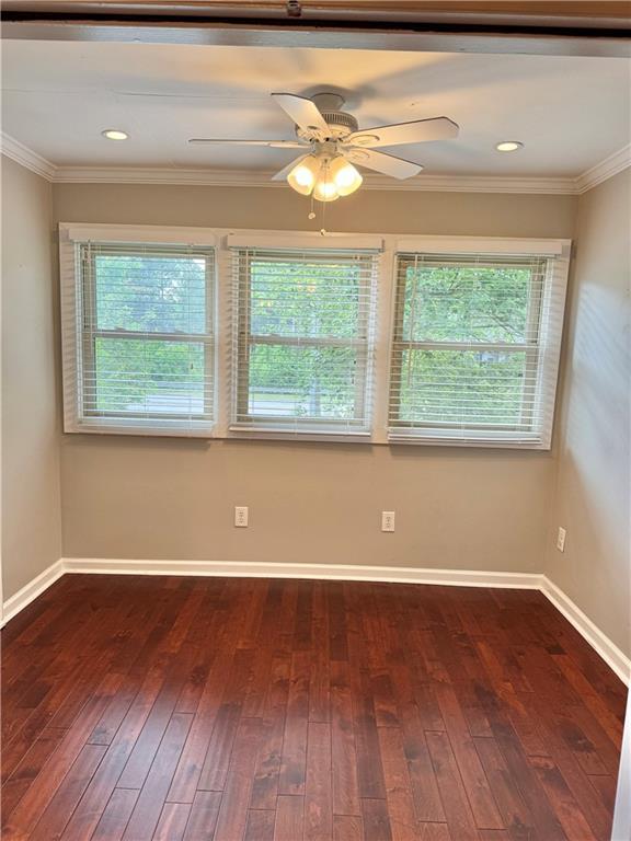 121 Brittany Ct, Duluth, GA 30096 - unfurnished room featuring healthy amount of natural light, dark wood-type flooring, crown molding, and baseboards