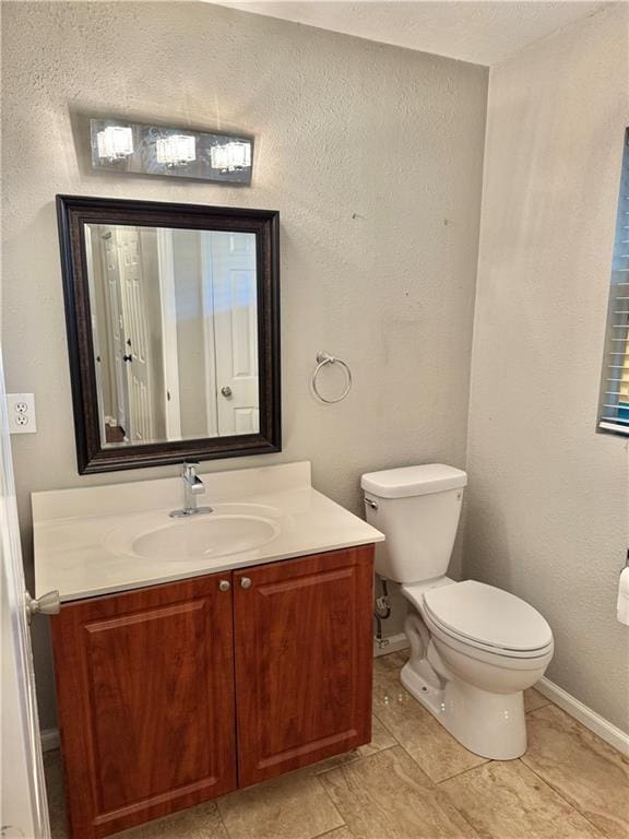 121 Brittany Ct, Duluth, GA 30096 - half bath featuring toilet, vanity, baseboards, and tile patterned floors