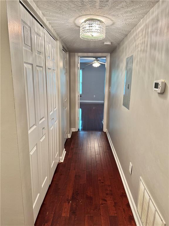 121 Brittany Ct, Duluth, GA 30096 - corridor with dark wood-type flooring, baseboards, and electric panel