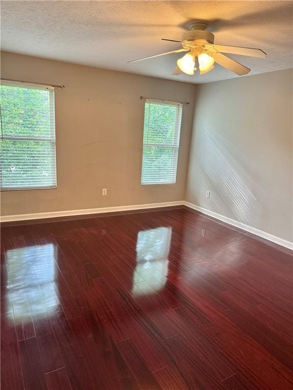 121 Brittany Ct, Duluth, GA 30096 - spare room featuring baseboards, dark wood-style floors, ceiling fan, and a textured ceiling