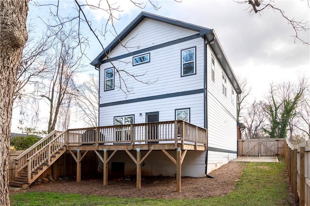 back of property featuring a wooden deck, a gate, a fenced backyard, and stairway