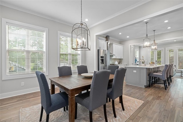 dining area with a chandelier, light wood-style flooring, baseboards, recessed lighting, and crown molding
