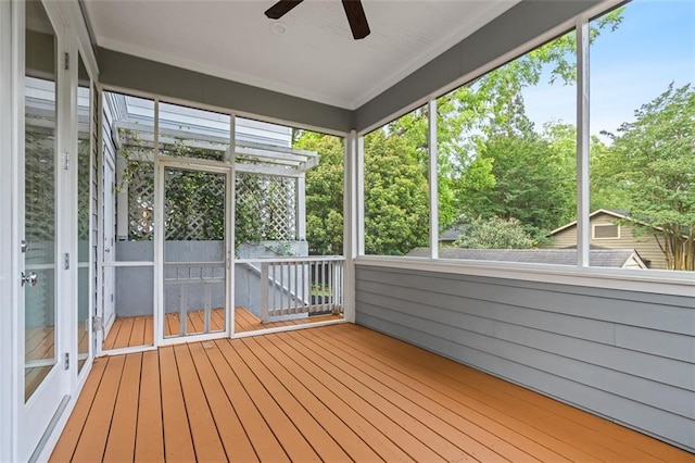 unfurnished sunroom featuring ceiling fan