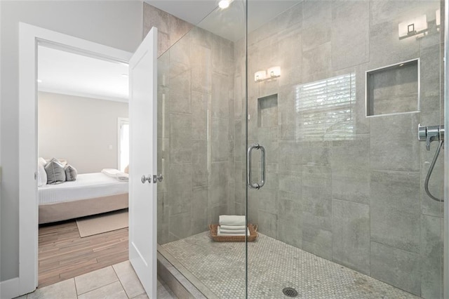 ensuite bathroom featuring a stall shower and tile patterned flooring