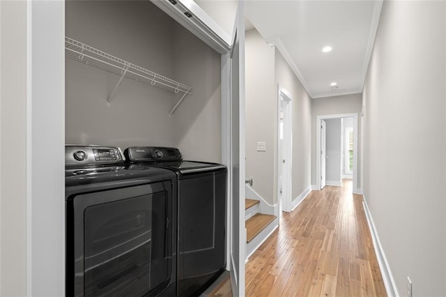 laundry room featuring light wood finished floors, independent washer and dryer, ornamental molding, baseboards, and recessed lighting