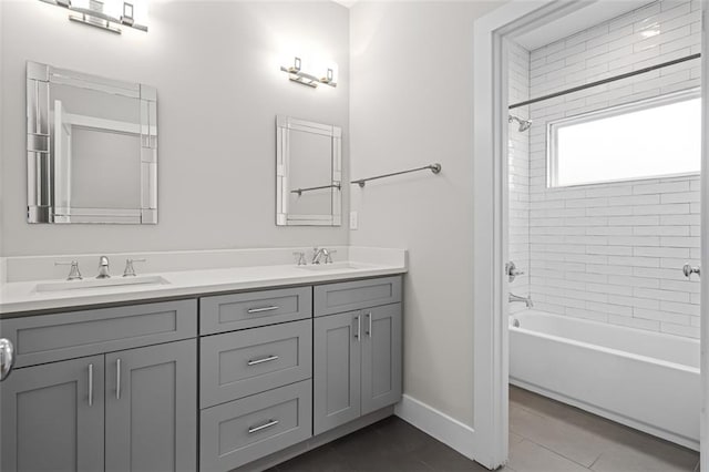 full bath with double vanity, tile patterned floors, tub / shower combination, and baseboards