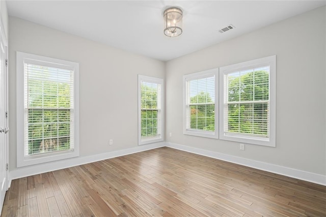 empty room with baseboards and wood finished floors