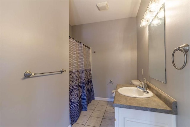 bathroom featuring tile patterned flooring, vanity, and toilet