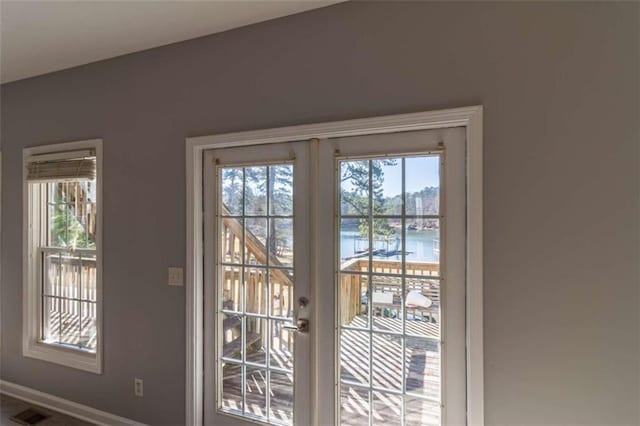 doorway to outside with french doors and a water view