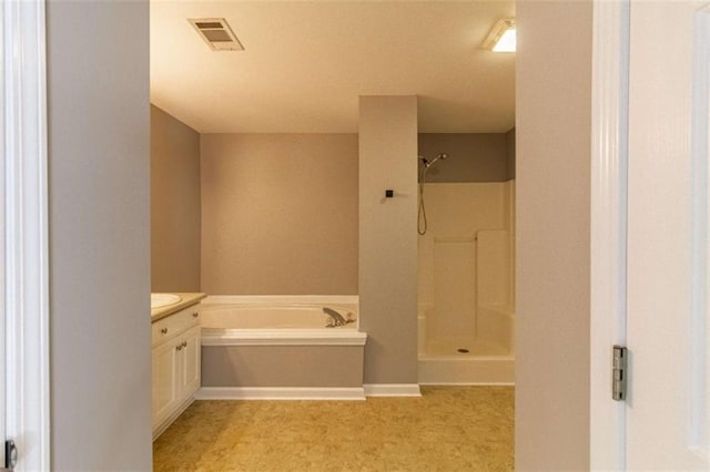 bathroom with vanity and independent shower and bath