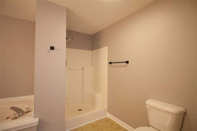 bathroom with toilet and walk in shower