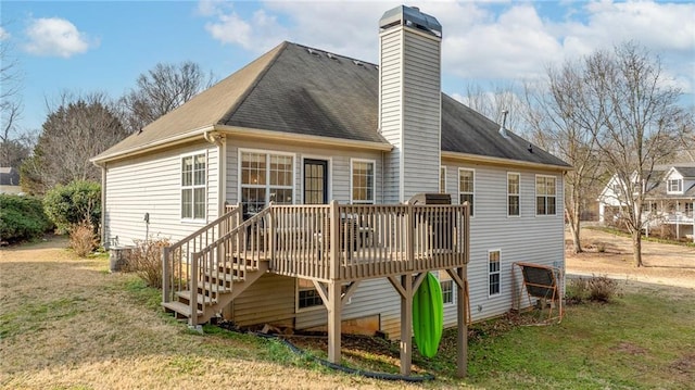 rear view of property featuring a deck and a lawn