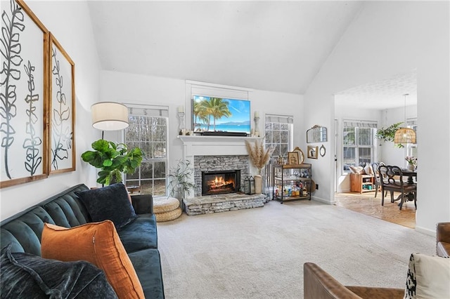 carpeted living room featuring a fireplace and high vaulted ceiling