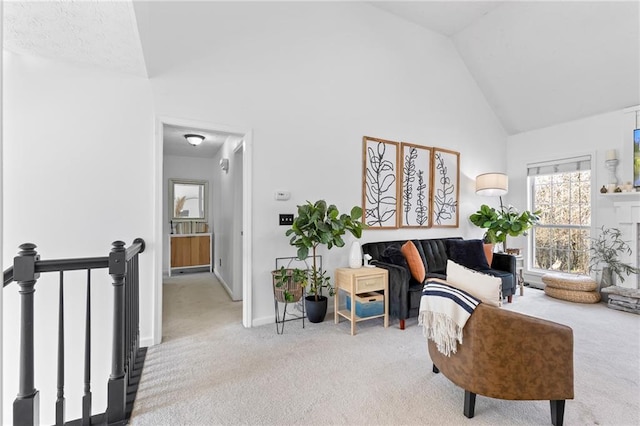 sitting room featuring high vaulted ceiling and carpet