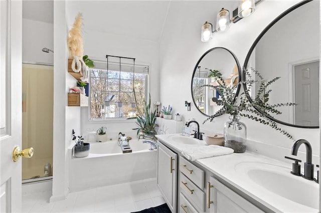 bathroom featuring a washtub, vanity, and lofted ceiling