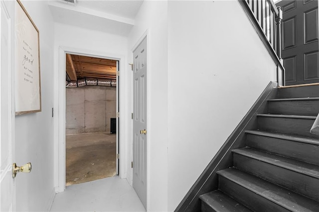 stairs featuring concrete floors