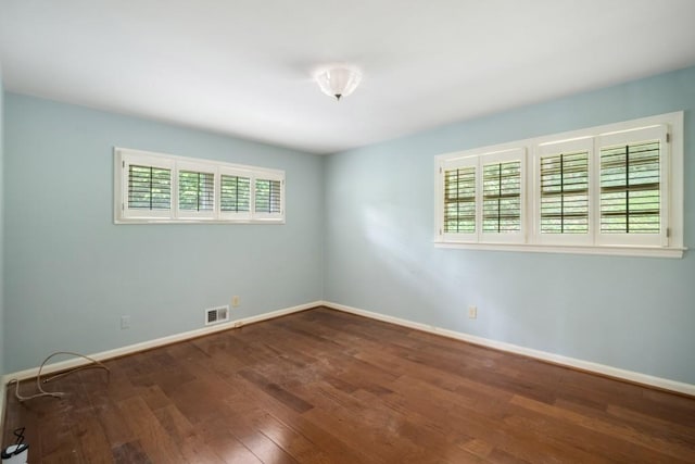 2556 Defoors Ferry Rd NW, Atlanta, GA 30318 - empty room featuring plenty of natural light, wood-type flooring, and baseboards