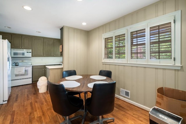 2556 Defoors Ferry Rd NW, Atlanta, GA 30318 - dining room with wood finished floors, recessed lighting, and a decorative wall