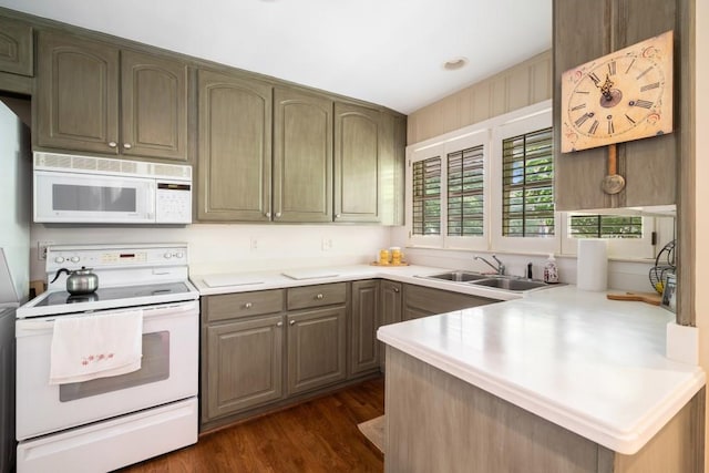 2556 Defoors Ferry Rd NW, Atlanta, GA 30318 - kitchen with white appliances, a sink, a peninsula, light countertops, and dark wood-style floors